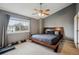 This bedroom features a ceiling fan, a gray accent wall, and a window with natural light at 4117 S Mobile Cir # C, Aurora, CO 80013
