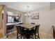 Dining area adjacent to kitchen with a modern chandelier, counter seating, and a decorative painting enhancing the neutral walls at 4117 S Mobile Cir # C, Aurora, CO 80013