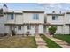 Charming townhome featuring a well-maintained lawn and a welcoming entrance with concrete steps and neutral-colored siding at 4117 S Mobile Cir # C, Aurora, CO 80013
