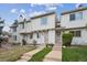 Charming townhome featuring a well-maintained lawn and a welcoming entrance with concrete steps and neutral-colored siding at 4117 S Mobile Cir # C, Aurora, CO 80013