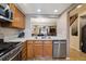 A well-appointed kitchen showcases wooden cabinets, stainless steel appliances, and an open design leading into the dining area at 4117 S Mobile Cir # C, Aurora, CO 80013