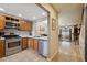 The kitchen features wood cabinets, stainless steel appliances, tile countertops, and an open layout overlooking the dining area at 4117 S Mobile Cir # C, Aurora, CO 80013
