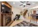 Inviting living room with brick fireplace, ceiling fan, and staircase to the upper level, with natural light at 4117 S Mobile Cir # C, Aurora, CO 80013