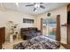 Cozy living room with sliding glass doors to the backyard, a ceiling fan, and a comfortable brown sofa at 4117 S Mobile Cir # C, Aurora, CO 80013