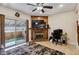 Comfortable living room features a brick fireplace, ceiling fan, and sliding glass doors opening to the backyard at 4117 S Mobile Cir # C, Aurora, CO 80013