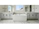 Luxury bathroom featuring a soaking tub, double vanities and marble flooring at 5722 Farrier Pt, Castle Rock, CO 80104