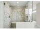 Modern walk-in shower with dual shower heads and marble tile at 5722 Farrier Pt, Castle Rock, CO 80104