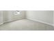 Empty bedroom featuring neutral carpet, white trim and baseboards, and a window at 5722 Farrier Pt, Castle Rock, CO 80104