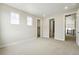 Bedroom featuring two windows, carpet and access to a bathroom and closet at 5722 Farrier Pt, Castle Rock, CO 80104