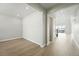 Neutral-colored empty room with hardwood floors, recessed lighting, and a large doorway at 5722 Farrier Pt, Castle Rock, CO 80104