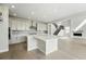 Bright kitchen featuring stainless steel appliances, island, and access to the staircase at 5722 Farrier Pt, Castle Rock, CO 80104