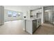 Modern kitchen island with stainless steel dishwasher and view of the living room at 5722 Farrier Pt, Castle Rock, CO 80104