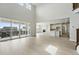 Spacious living room featuring wood floors, large windows, high ceilings, and an open floor plan at 5722 Farrier Pt, Castle Rock, CO 80104