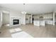Open living area featuring a fireplace, modern chandelier, hardwood floors and kitchen access at 5722 Farrier Pt, Castle Rock, CO 80104