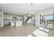 Open concept living space with modern kitchen, dining area, and access to a balcony at 5722 Farrier Pt, Castle Rock, CO 80104