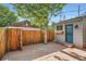Cozy backyard with stone patio, privacy fence, and mature trees for shade at 320 E Dakota Ave, Denver, CO 80209