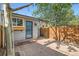 Backyard features a paver patio and a wooden fence for privacy at 320 E Dakota Ave, Denver, CO 80209