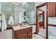 Well-appointed bathroom featuring decorative wallpaper, a marble countertop vanity, and traditional fixtures at 320 E Dakota Ave, Denver, CO 80209