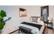 Cozy bedroom with modern decor, plush bedding, and soft natural light from a decorative window at 320 E Dakota Ave, Denver, CO 80209