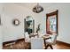 Charming dining room featuring a modern light fixture, wood floors, and decorative mirror at 320 E Dakota Ave, Denver, CO 80209