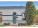 Charming home featuring a blue door, brick exterior, and a well-maintained front garden at 320 E Dakota Ave, Denver, CO 80209