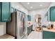 Modern kitchen with stainless steel appliances, opening into a bright dining area at 320 E Dakota Ave, Denver, CO 80209