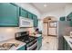 Well-equipped kitchen with stainless steel appliances and ample counter space at 320 E Dakota Ave, Denver, CO 80209