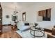 Inviting living area with hardwood floors and comfortable seating, leading into the dining room at 320 E Dakota Ave, Denver, CO 80209