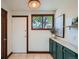Mud room with built-in green cabinetry, large window, and an exterior door at 320 E Dakota Ave, Denver, CO 80209