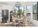 Dining area featuring stainless steel refrigerator and wine storage near table with modern light fixture at 3900 W 111Th Ave, Westminster, CO 80031