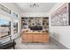 Well-lit home office with custom built-in shelving and a spacious wooden desk at 3900 W 111Th Ave, Westminster, CO 80031