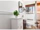 The bathroom features a white vanity, unique sink, and fixtures, with natural light from the window enhancing the serene atmosphere at 1419 Dexter St, Denver, CO 80220