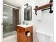 Charming bathroom features a walk-in shower, decorative mirror, and wood cabinet with sleek modern hardware at 1419 Dexter St, Denver, CO 80220