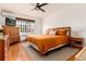 Inviting bedroom with a large window, hardwood floors, ceiling fan, and stylish furnishings, offering comfort and natural light at 1419 Dexter St, Denver, CO 80220