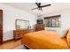 This bedroom features a large window, stylish wooden furniture, hardwood floors, and a comfortable bed setting at 1419 Dexter St, Denver, CO 80220
