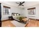 This bedroom offers hardwood floors, two large windows for ample light, and a comfortable setting with neutral tones at 1419 Dexter St, Denver, CO 80220