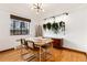 Dining room featuring a glass table, modern chairs, and a unique hanging plant display at 1419 Dexter St, Denver, CO 80220