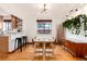 Dining room featuring a glass table, modern chairs, and a unique hanging plant display at 1419 Dexter St, Denver, CO 80220
