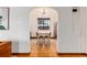 Dining room viewed through archway with hardwood floors and light fixtures at 1419 Dexter St, Denver, CO 80220