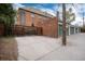 Exterior shot of the brick building with multiple garage doors and parking at 1419 Dexter St, Denver, CO 80220