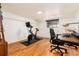 This versatile room features hardwood floors, natural light, and fitness equipment, perfect for an in-home gym or office space at 1419 Dexter St, Denver, CO 80220