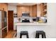 This cozy kitchen boasts wooden cabinets, stainless steel appliances, and a breakfast bar with stool seating at 1419 Dexter St, Denver, CO 80220