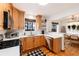 Bright kitchen featuring white countertops, stainless steel appliances, wooden cabinets, and an adjacent dining area at 1419 Dexter St, Denver, CO 80220