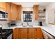 This kitchen features wooden cabinets, stainless steel appliances, white countertops, and a cozy breakfast nook at 1419 Dexter St, Denver, CO 80220