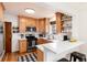 Charming kitchen features wooden cabinets, stainless steel appliances, and a breakfast bar, blending style with functionality at 1419 Dexter St, Denver, CO 80220