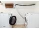 Laundry room with tile flooring, washer, dryer, and small window with woven blinds at 1419 Dexter St, Denver, CO 80220