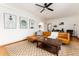 Bright living room featuring a leather sectional, hardwood floors, a modern rug, and modern art on the walls at 1419 Dexter St, Denver, CO 80220