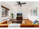 Bright living room featuring a leather sectional, hardwood floors, and a large window at 1419 Dexter St, Denver, CO 80220