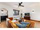 Bright living room featuring a leather sectional, hardwood floors, and a large window with natural light at 1419 Dexter St, Denver, CO 80220