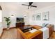 Bright living room featuring a leather sectional, hardwood floors, and modern art on the walls at 1419 Dexter St, Denver, CO 80220